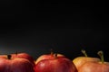 Red juicy apples. Ripe red apples on black background. Beautiful apples are ideal shape. Top view with space for your text.