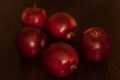 Red juicy apples on a wooden tabletop.