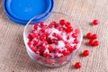 Red juicy berries of a viburnum with sugar in a glass jar on a wooden background. For making jam, tea Royalty Free Stock Photo