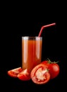 Red, juicy, fresh tomatoes and tomato juice on a black background Royalty Free Stock Photo