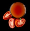 Red, juicy, fresh tomatoes and tomato juice on a black background Royalty Free Stock Photo