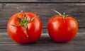 Red, juicy, fresh tomatoes on a wooden background Royalty Free Stock Photo