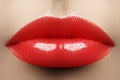 Red juicy lip gloss on lips. Beautiful makeup with best cosmetics. Closeup of mouth with fashion make-up. Part of face Royalty Free Stock Photo