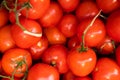 Red juicy meaty pile of glazed tomatoes with brunches close-up, vegetable background, salad ingredient Royalty Free Stock Photo