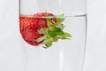 Strawberries in a glass of sparkling water on a white background closeup Royalty Free Stock Photo