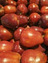 Red juicy sweet apples in bright sunlight at super market store