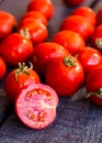 Red juicy tomatoes cherry on dark wooden board Royalty Free Stock Photo