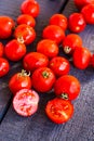 Red juicy tomatoes cherry on dark wooden board Royalty Free Stock Photo