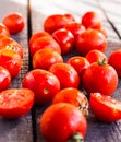 Red juicy tomatoes cherry on dark wooden board Royalty Free Stock Photo