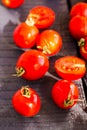 Red juicy tomatoes cherry on dark wooden board Royalty Free Stock Photo