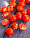 Red juicy tomatoes cherry on dark wooden board Royalty Free Stock Photo
