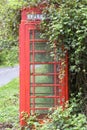 Red K6 phone box covered by brambles Royalty Free Stock Photo