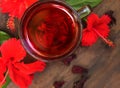 Red karkade hibiscus red sorrel tea in glass mug with dry tea cu