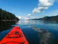 Red kayak and blue sky in the water. Royalty Free Stock Photo