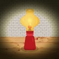 red kerosene lamp on the background of a brick wall on a wooden table Royalty Free Stock Photo