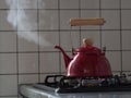 Red kettle steaming hot. Royalty Free Stock Photo