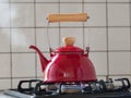 Red kettle steaming hot. Royalty Free Stock Photo