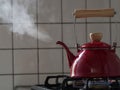 Red kettle steaming hot. Royalty Free Stock Photo