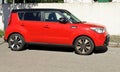 Red Kia Soul, subcompact suv of the south korean automaker, on concrete wall background. Side view. Royalty Free Stock Photo