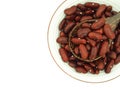 Red kidney beans in wooden spoon over white bowl isolated on a white background. Royalty Free Stock Photo