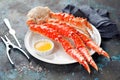 Red king crab legs with butter sauce on a plate Royalty Free Stock Photo