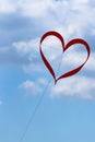Red kite in the shape heart of flying  on valentine`s day Royalty Free Stock Photo