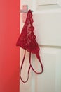 Red Knickers hanging off a bedroom door handle Royalty Free Stock Photo