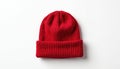 Red knitted beanie hat displayed front view on plain white backdrop. Cuff folded up, ideal for mockups, branding, custom logo, Royalty Free Stock Photo