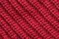 Red knitted fabric as an abstract texture. Knitting, elastic band pattern, English elastic band. Diagonal rows. Close-up Royalty Free Stock Photo