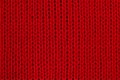Red knitted fabric macro photo. Detail of clothes as a red background Royalty Free Stock Photo