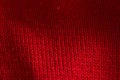Red knitted sweater close-up. Material background, macro Royalty Free Stock Photo