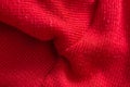 Red knitted sweater close-up. Material background, macro Royalty Free Stock Photo