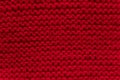 Red knitted sweater texture background, wool fabric closeup with detailed stitch pattern. Royalty Free Stock Photo