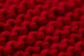 Red knitted wool macro texture, abstract textile background with rough stitch structure. Royalty Free Stock Photo