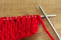 Red knitting wool, knitting needles