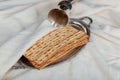 Red kosher wine with a white plate of matzah or matza and a Passover Haggadah