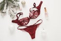 Red lace lingerie and perfume jar. Gift set of women`s accessories and underwear on flat lay.