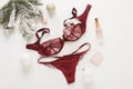 Red lace lingerie and perfume bottle. Gift set of women`s accessories and underwear on flat lay.