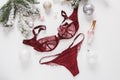 Red lace lingerie and perfume bottle. Gift set of women`s accessories and underwear on flat lay.