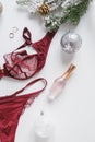 Red lace lingerie and perfume bottle. Top view. Gift set of women`s accessories and underwear.