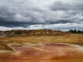 Red lake because of the clay. Natural clay quarry. Overcast sky