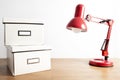 Red lamp and boxes on a wooden table Royalty Free Stock Photo