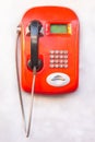 Red landline phone with buttons on the wall Royalty Free Stock Photo