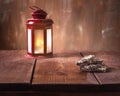 Red lantern on a brown table and chocolates with nuts stacked Royalty Free Stock Photo