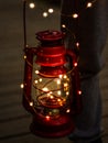 Red lantern with garland surrounding it in a dim environment