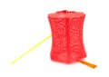 Red lantern with handle stands on white background