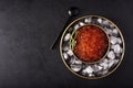 red large salted caviar in a small black plate