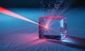 Red laser beam interacting with a transparent cube, creating light and scattering particles Royalty Free Stock Photo