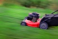 Red Lawn Mower in Lush Green Grass Mowing Lawn Royalty Free Stock Photo