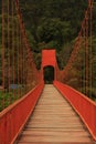 Red lead painted toll suspension footbridge Royalty Free Stock Photo